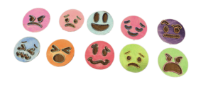 An arrangement of ten handmade tactile emojis, each featuring a cartoon face with a distinct expression. Each features raised outlines of the facial features painted many different colors on top of circular disks also of varying colors. 